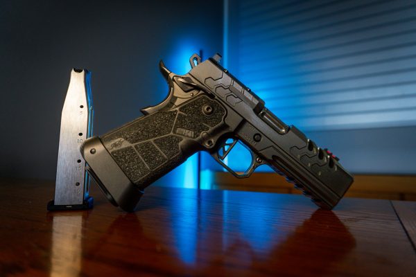 Kimber 2K11 Pro Comp pistol on wood table, left angle