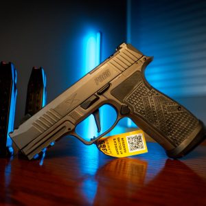 Sig Sauer P365 Legion Compact pistol on wood table, left angle