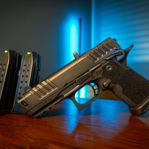 Staccato HD C4X 9mm pistol with magazines on wood table, left angle