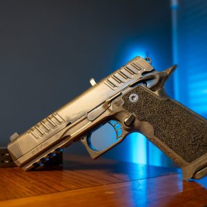 Staccato HD P4.5 9mm pistol on wood table, left angle