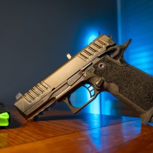 Staccato HD P4 9mm pistol on wood table, left angle