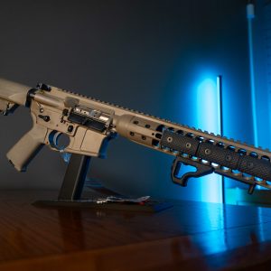 LWRC M6IC 5.56 rifle in tan, left side on stand