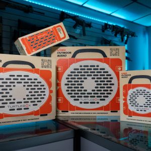 Turtlebox speakers of three sizes in orange retail boxes