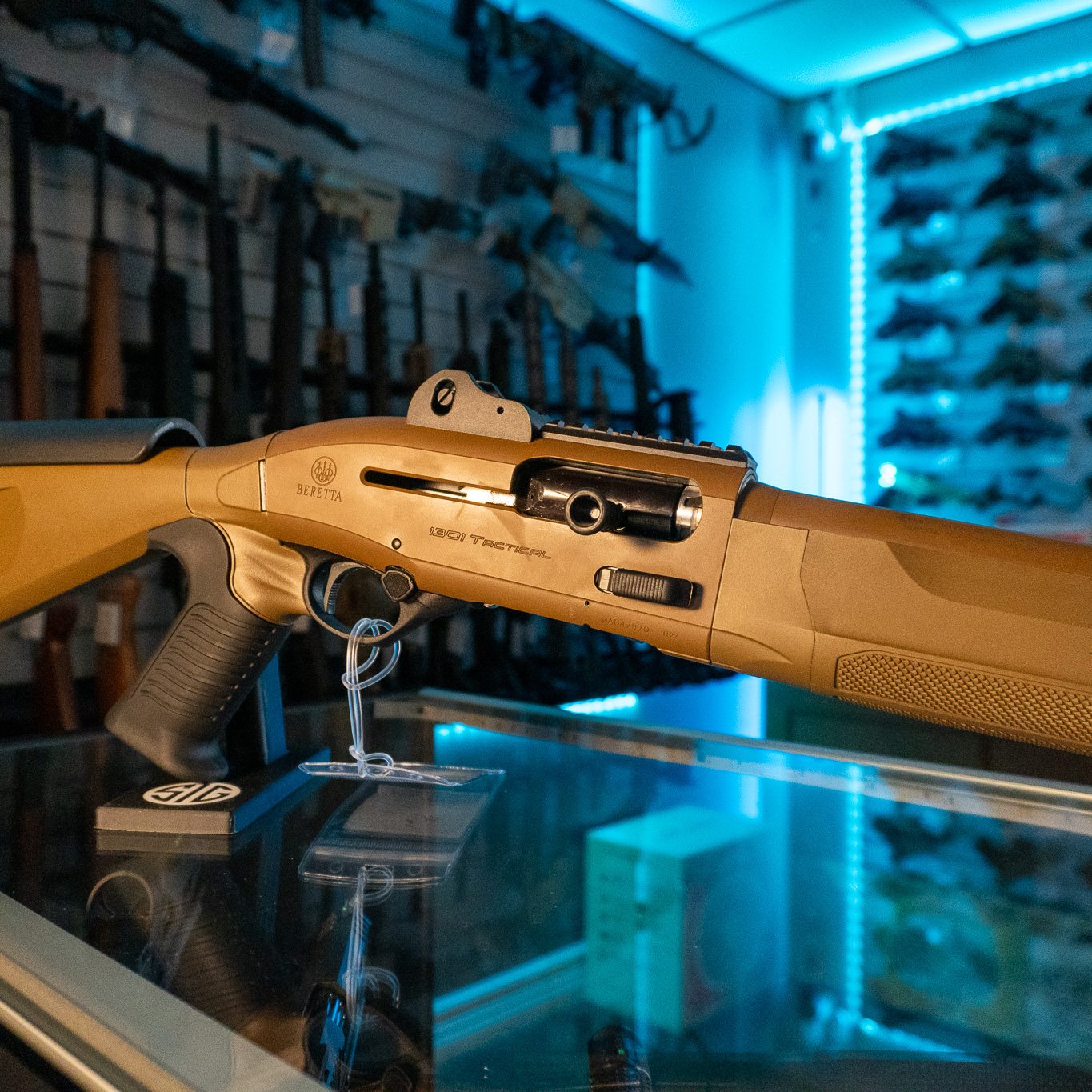 Close-up of the Beretta 1301 Tactical Mod 2 FDE receiver with the ghost ring rear sight and Picatinny rail