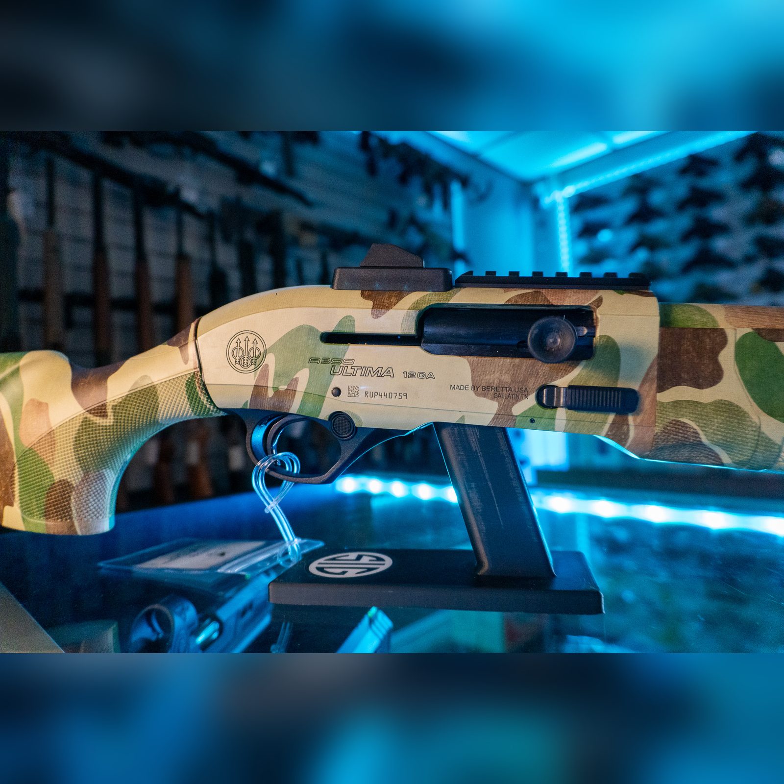 Close-up of the Beretta A300 Ultima 12GA receiver with Picatinny rail and extended bolt handle in Frogskin camo