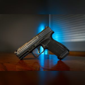 Canik METE MC9 Prime 9mm pistol with black nitride ported slide, black stippled polymer frame and flat aluminum trigger, left side