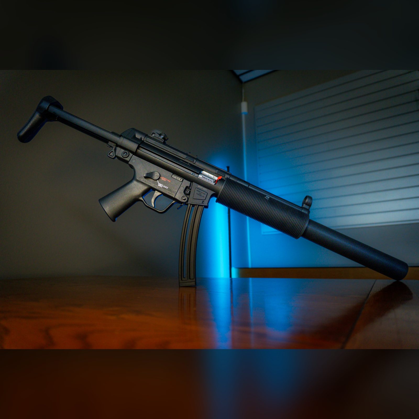 HK MP5 .22 LR rifle in matte black with SD-style faux suppressor shroud, retractable stock and 25-round magazine