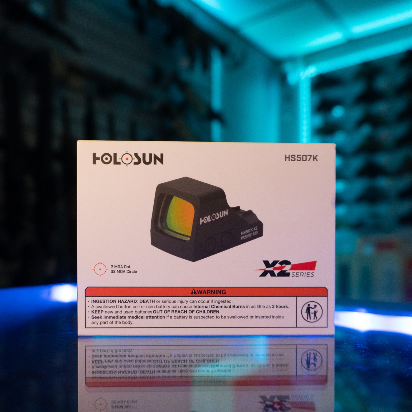 Holosun HS507K X2 red multi-reticle micro pistol sight in its retail box on a glass display counter