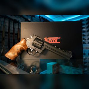 Korth Mongoose 8-Shot .357 Magnum revolver in black DLC, left side with Nighthawk Custom markings and walnut grip, in front of the Korth box