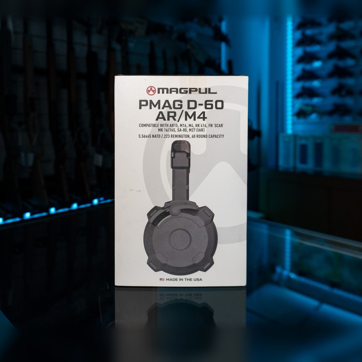 Magpul PMAG D-60 AR/M4 60-round drum magazine in its retail box on a glass display counter