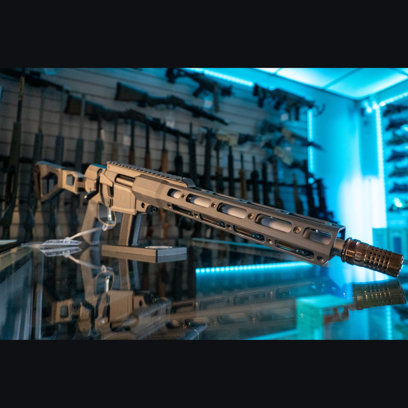 Q Mini Fix 5.56 NATO bolt action pistol in gray with folding brace, M-LOK handguard and bronze muzzle brake