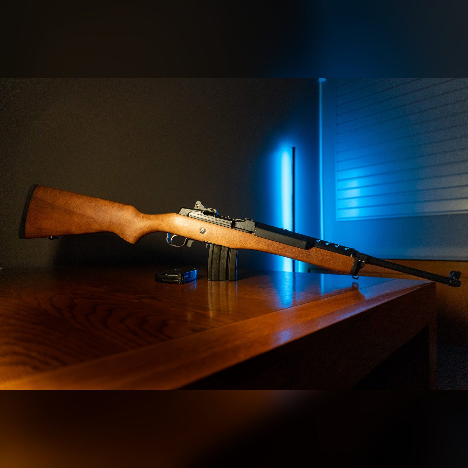 Ruger Mini-14 Ranch Rifle 5.56 NATO with hardwood stock and blued steel, right side, with a spare 20-round magazine