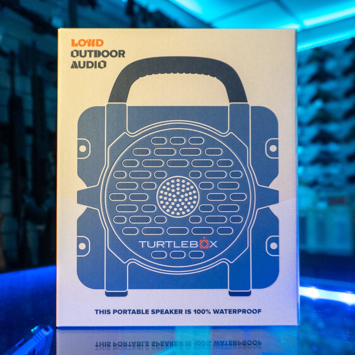 Turtlebox Cub portable Bluetooth speaker in gray, in its retail box