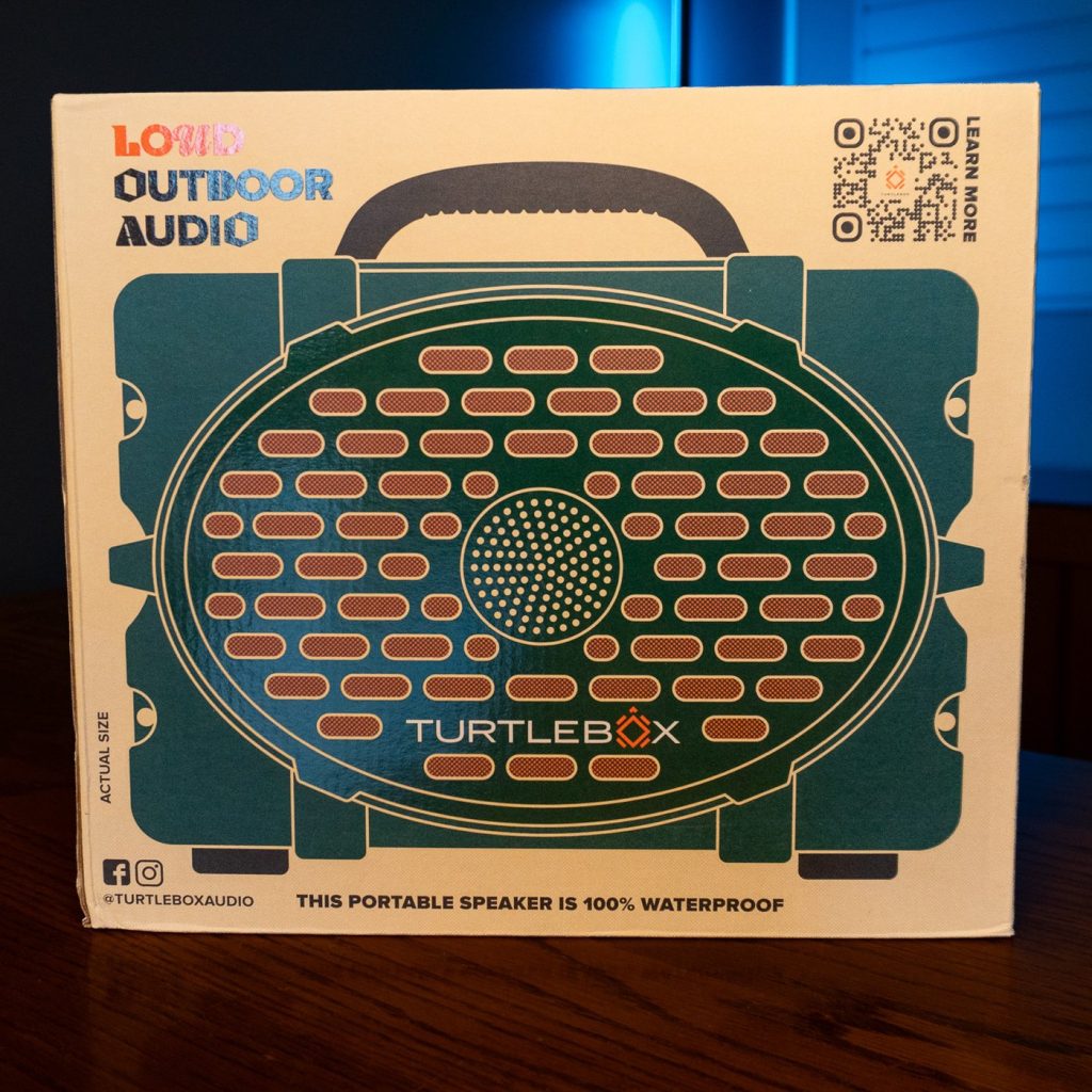Turtlebox Original Gen 3 Bluetooth speaker in green, in its retail box on a wooden table