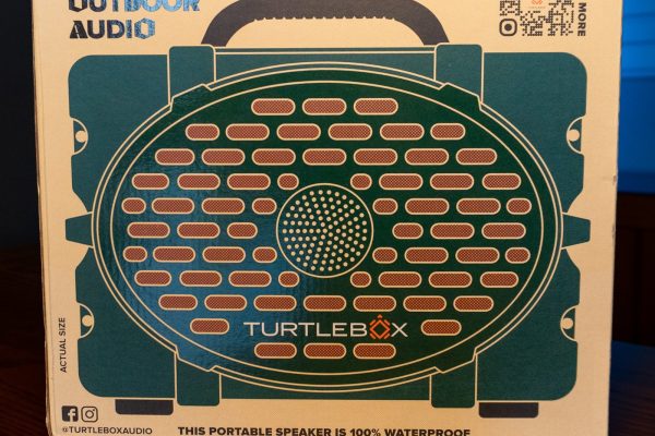 Turtlebox Original Gen 3 Bluetooth speaker in green, in its retail box on a wooden table